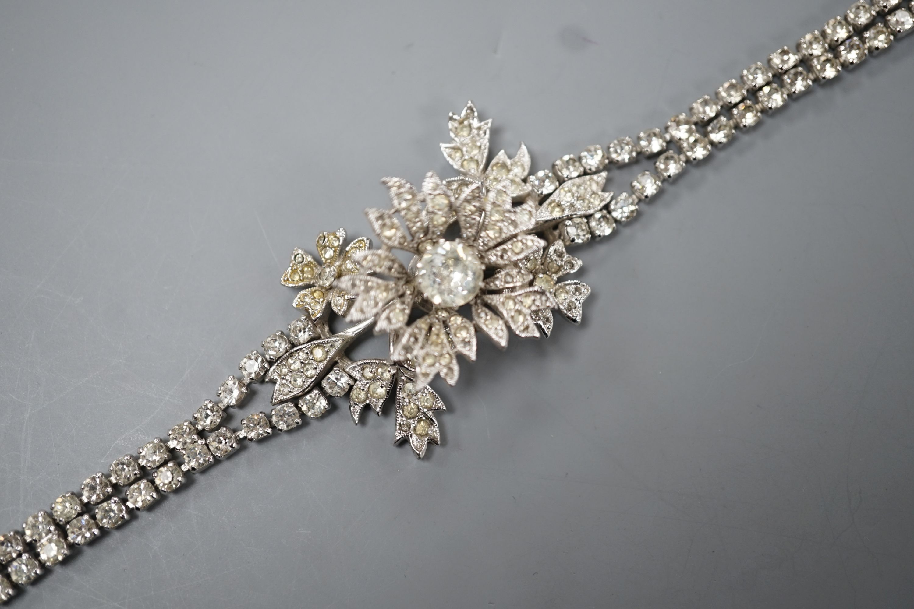 A Christian Dior paste cluster set bracelet, with central en tremblent floral motif, 19cm.